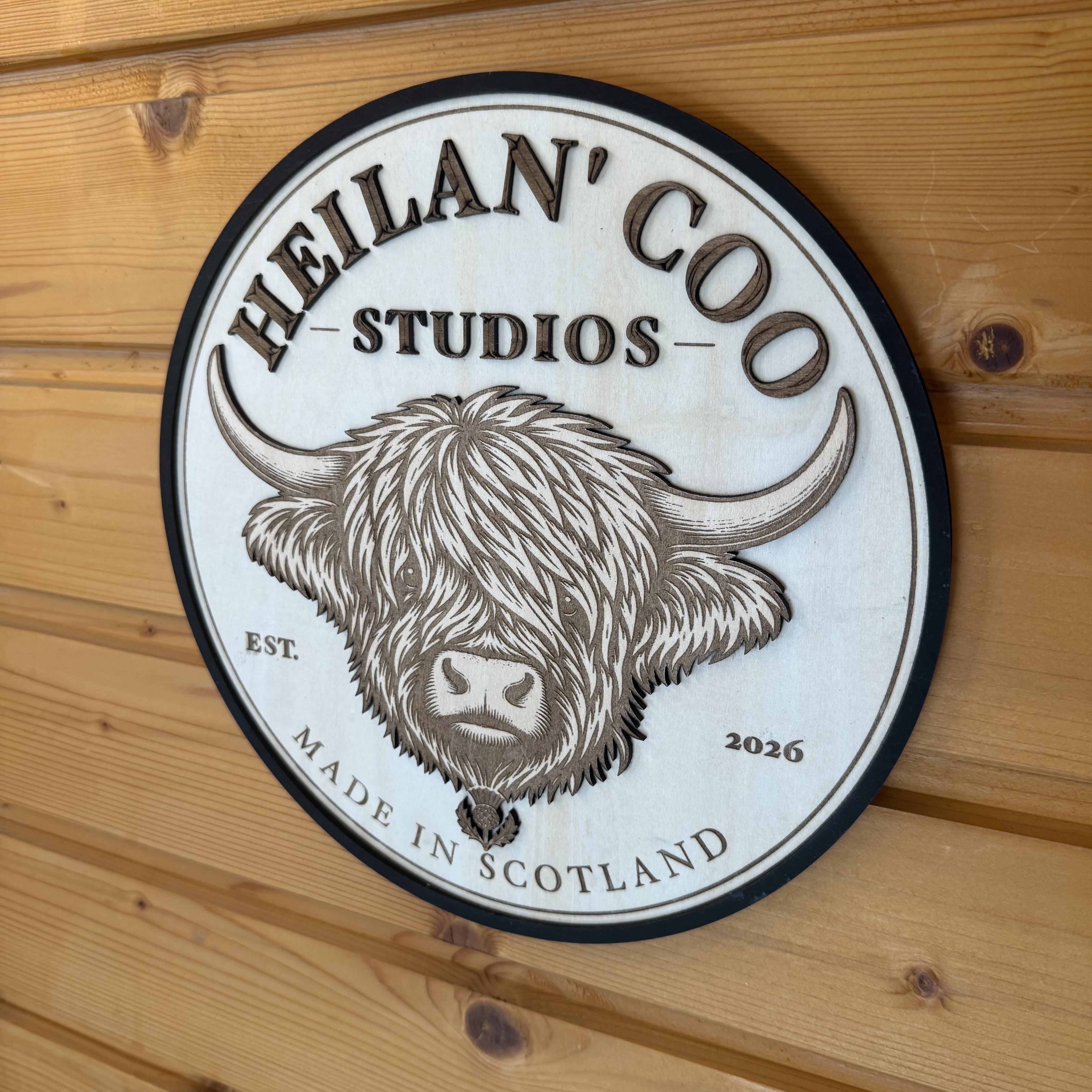 Selection of bespoke laser engraved slate and wooden gifts alongside custom 3D printed creations from Heiland Coo Studios in Scotland.