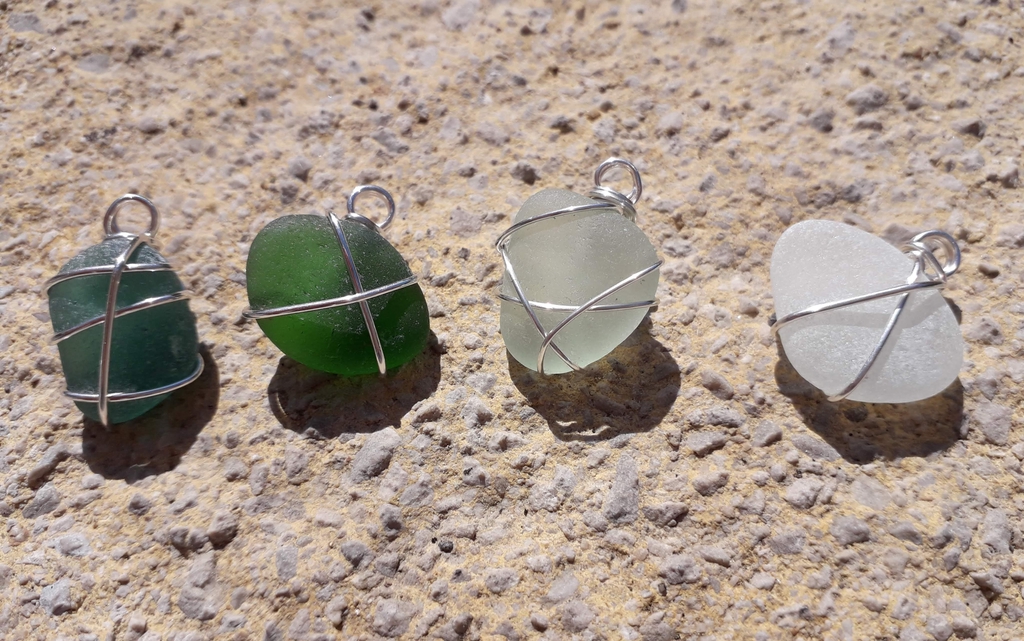 Authentic Cornish sea glass necklace pendants, hand-wrapped in durable stainless steel wire. Unique jewellery by CornishFinds. Sea glass found on Marazion beach, Cornwall.