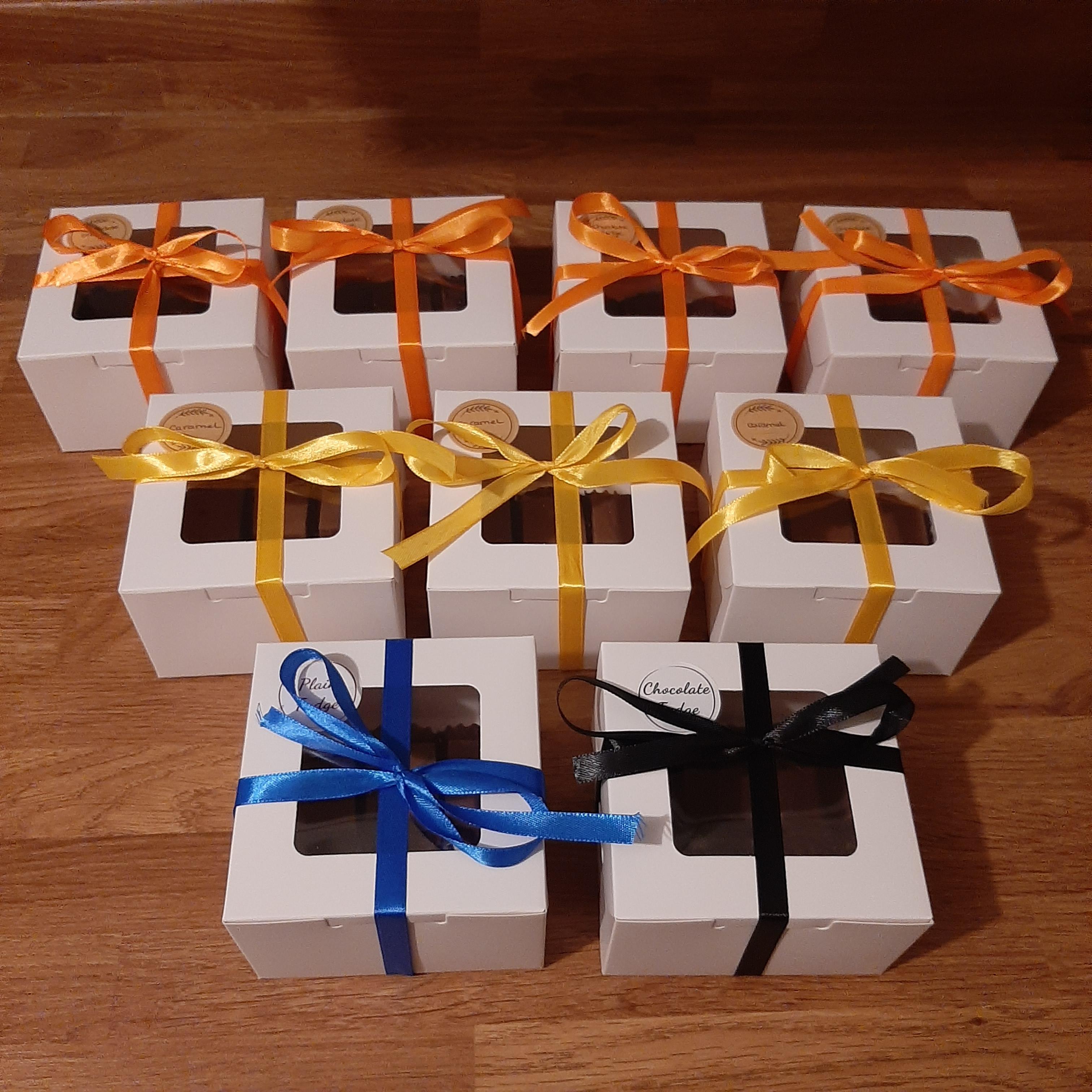 Image containing nine gift boxes, with different colour ribbons.