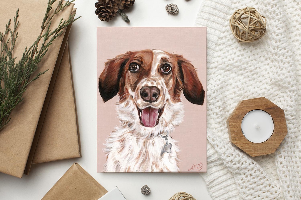 Portrait of a brown and white dog with a happy face, made with oil painting, lying on a white surface over a knitted white blanket, surrounded by a small white candle on the right side and by some brown craft paper envelopes on the left side.