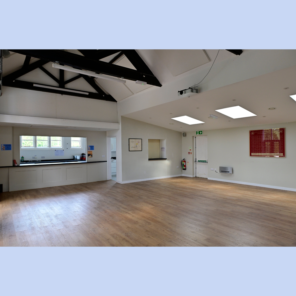 Oxhill Village Hall's main hall seen from the entrance, and looking towards the kitchen (behind the closed hatch) and the bar (open hatch). There's plenty of room for parties and get togethers, but it's not so big that people at a business meeting would find themselves rattling around.  
