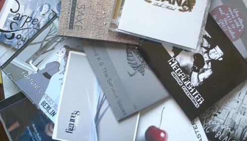 CDs spread out on the kitchen table