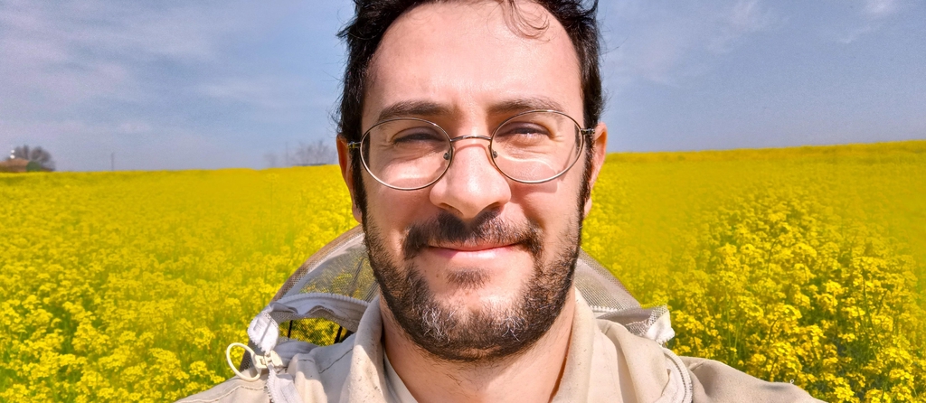 Marco Civico, apicoltore di Modena in un campo fiorito dove si produce miele artigianale