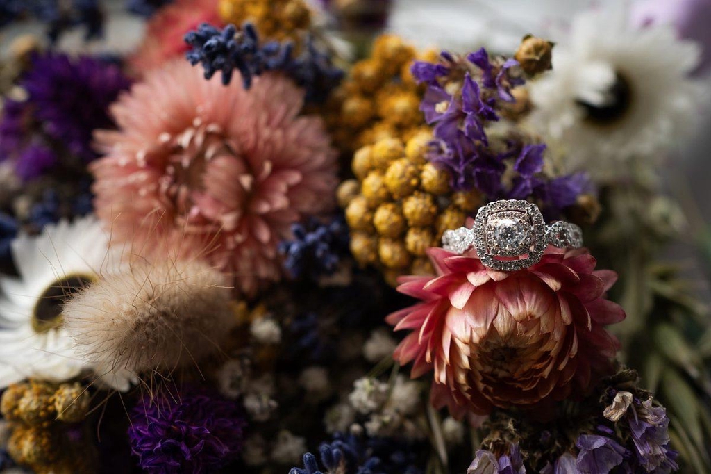 Wedding ring held with-in a dried flower arrangement