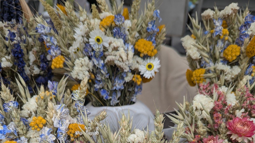 Dried flower displays in decorative vases