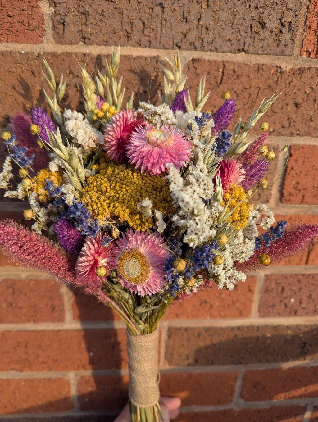 Bridal bouquet against red brick