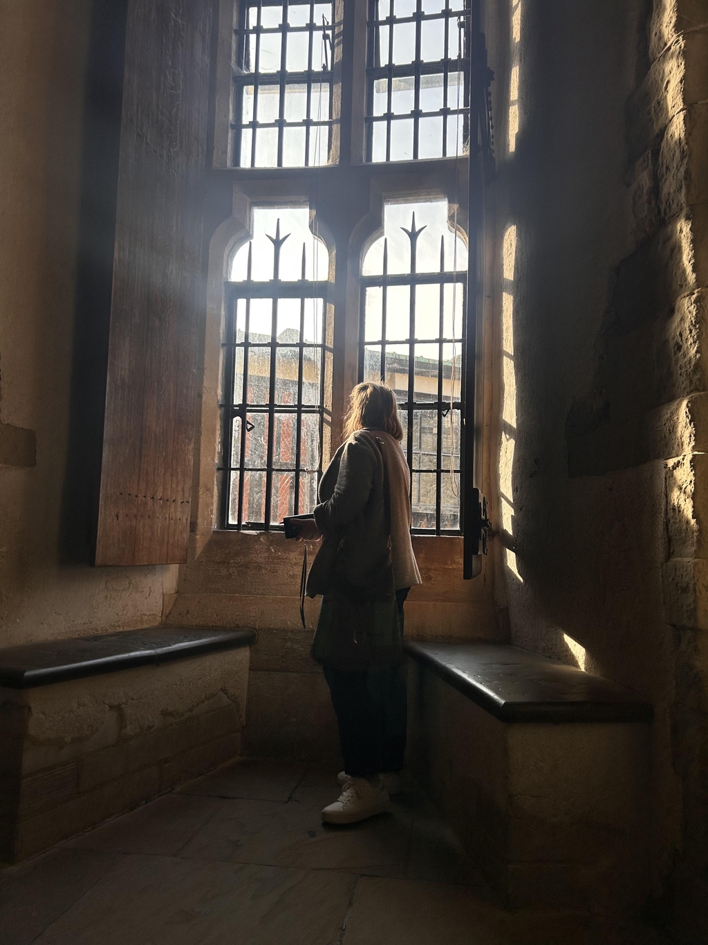 historian Jo Romero looking out of a window at the Tower of London
