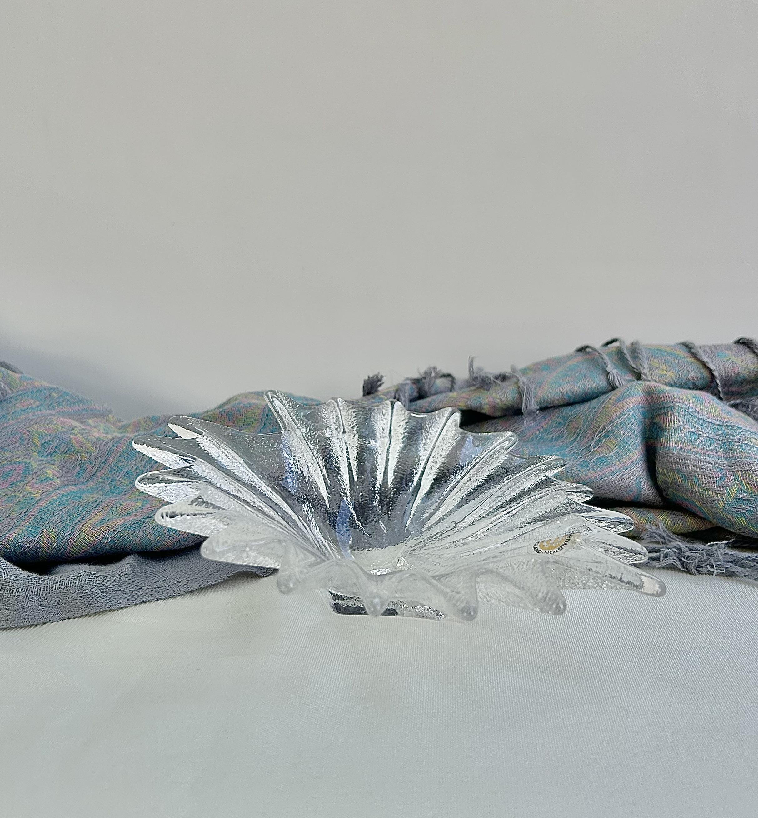 A curated collection of clear and monochrome pieces with sculptural lines, crisp silhouettes and modern, light‑catching forms