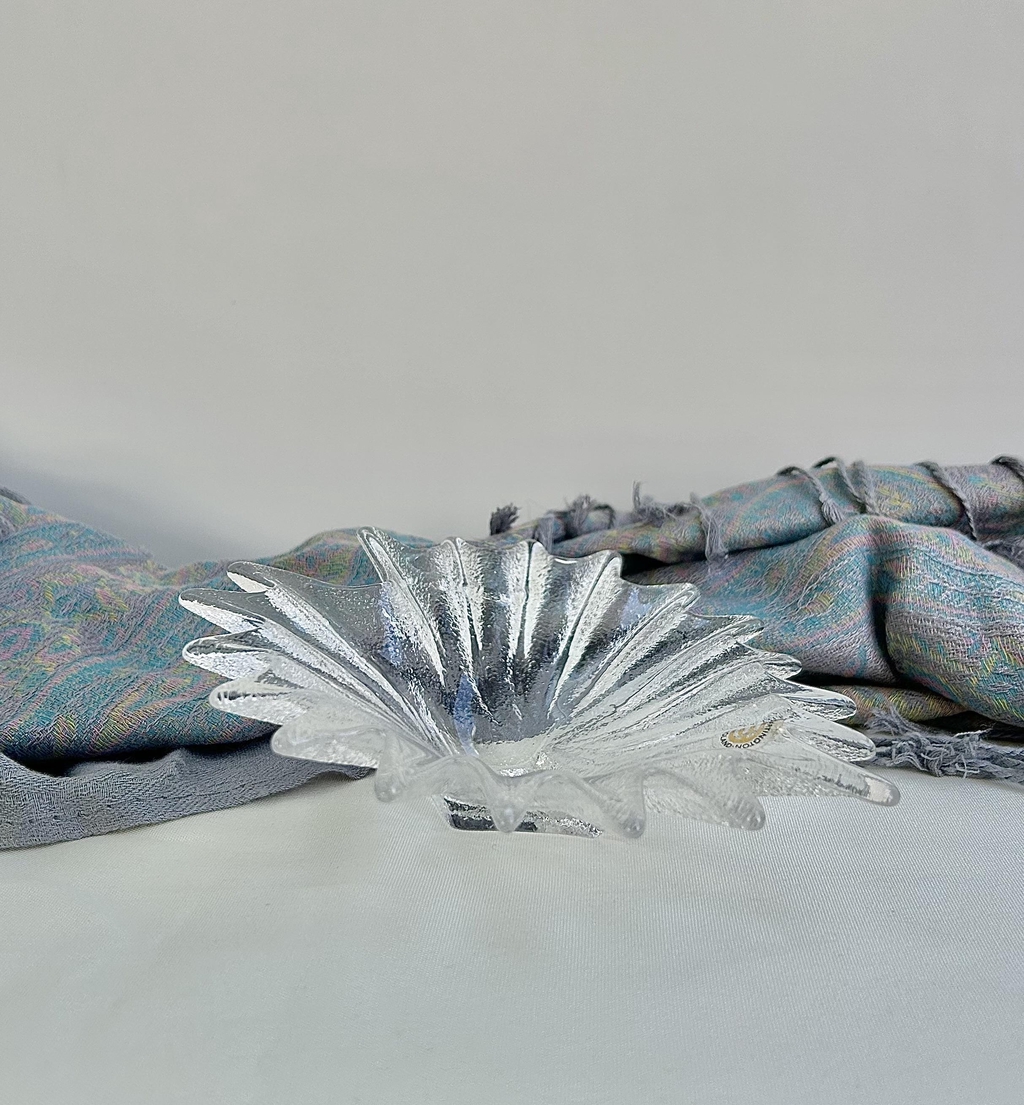 A curated collection of clear and monochrome pieces with sculptural lines, crisp silhouettes and modern, light‑catching forms