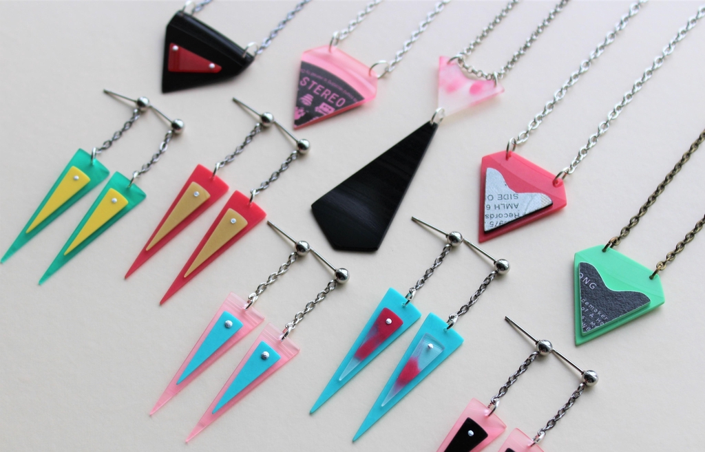 A selection of colourful earrings and necklaces handmade from recycled vinyl records