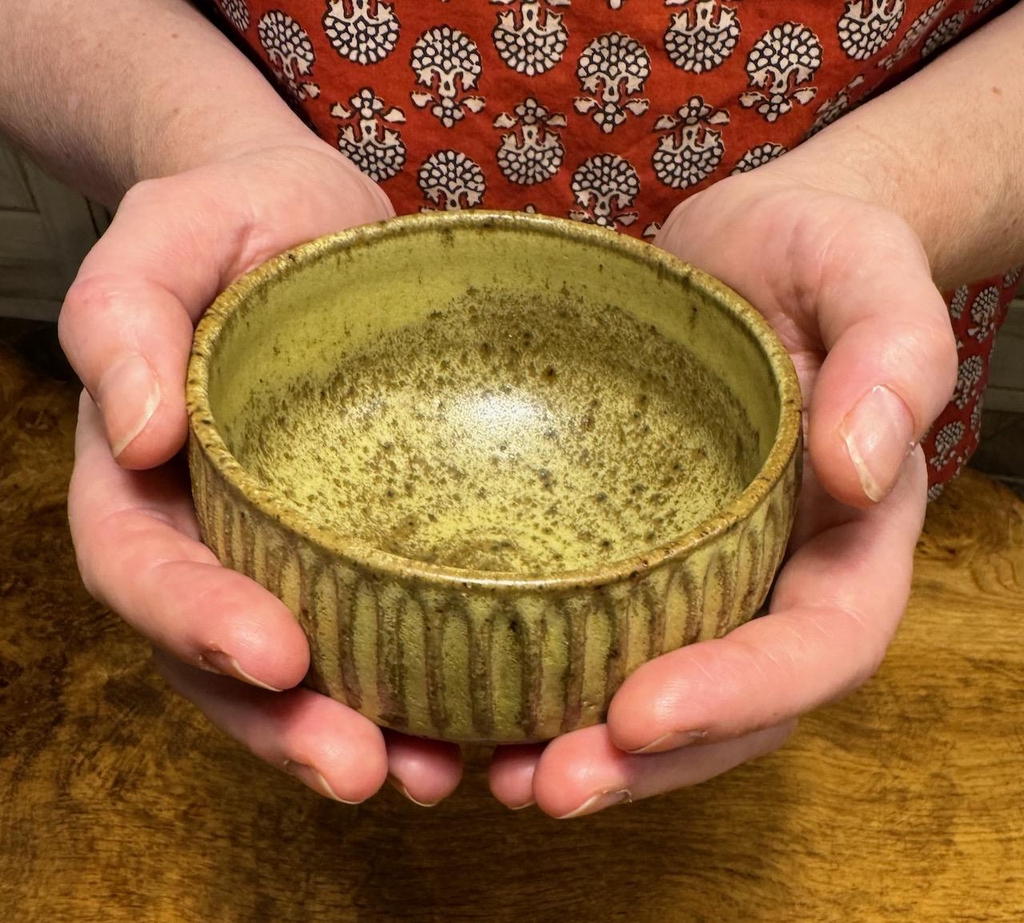 Oatmeal bowl shaped mug with no handles, held 