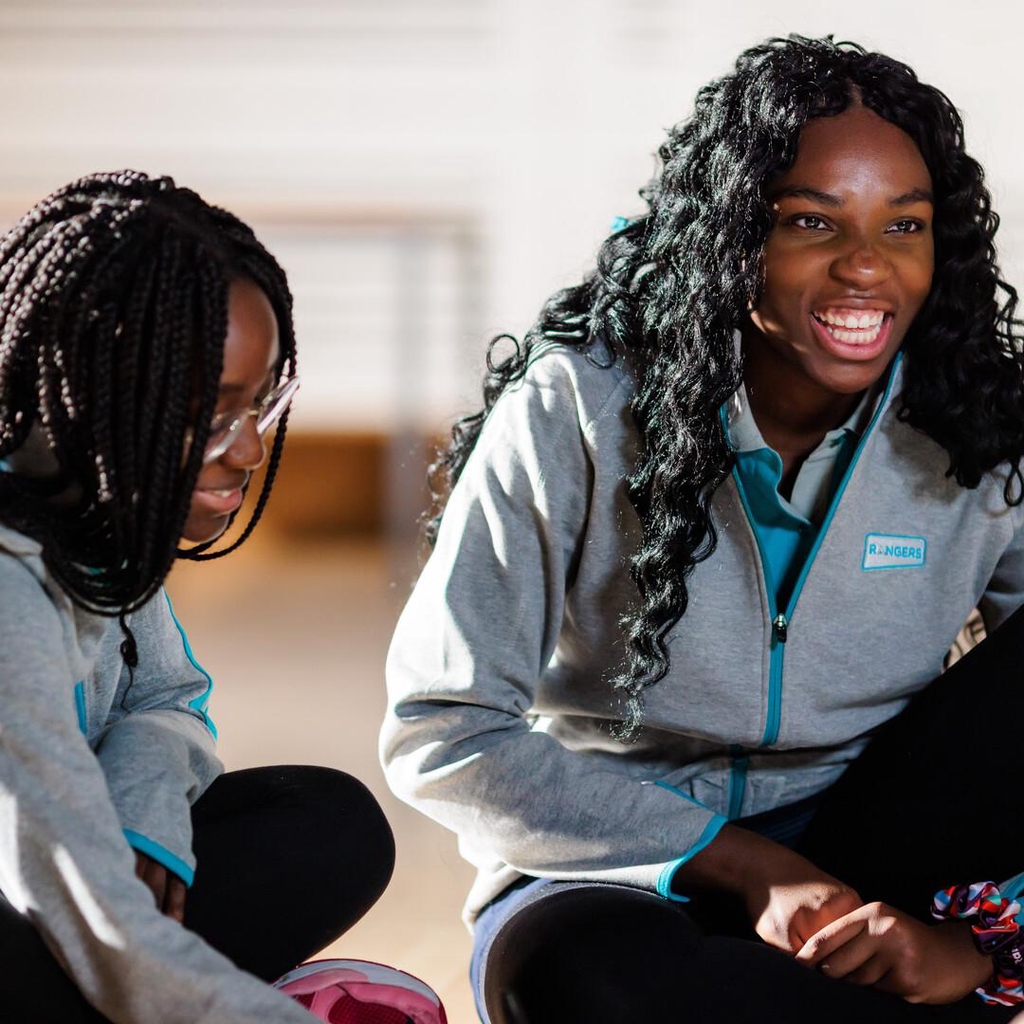 Photo of teenage girls chatting, wearing their Ranger uniform.