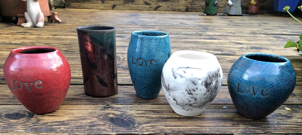 Row of ceramic pots made by David Allen of Elms Vale Pottery