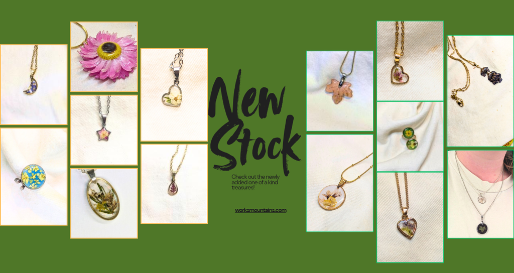 New stock banner advising to check out the new stock that has been added to the website, including photos of real leaf and flower necklace, real flower rings and other flower pendants 