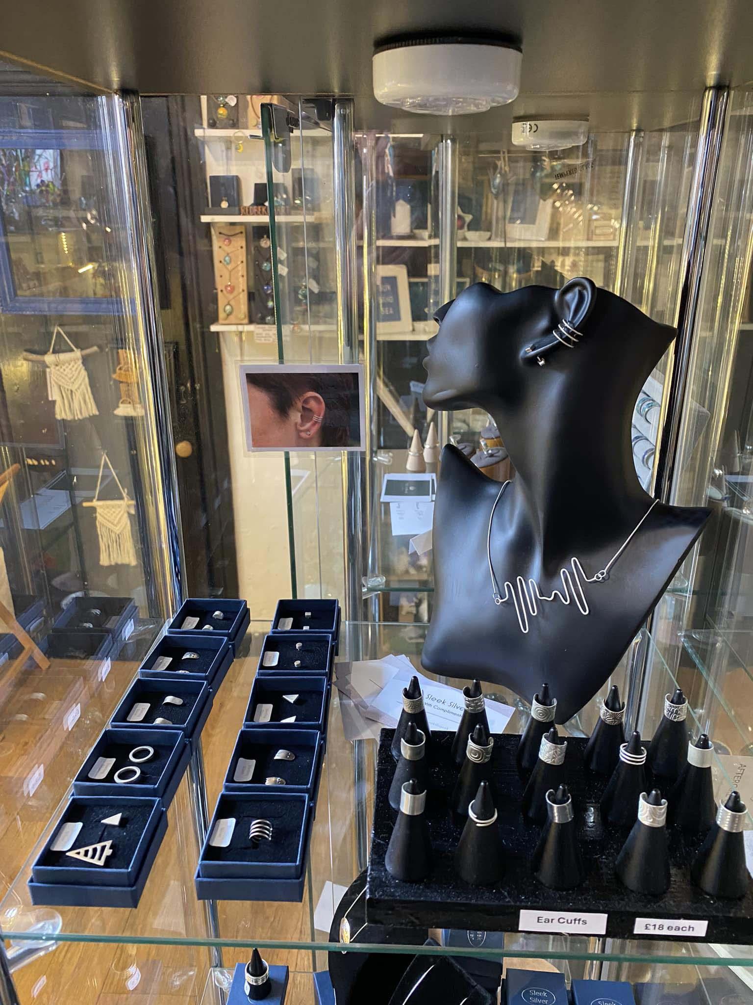 A glass display cabinet showing various collections from Sleek Silver Jewellery