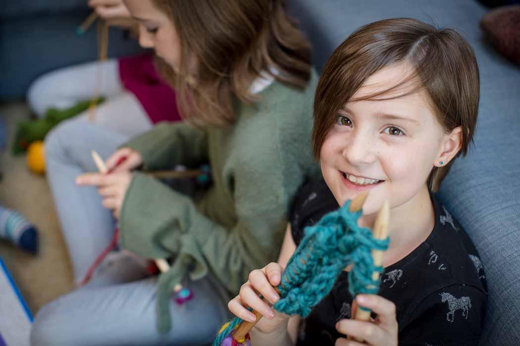 Craft sum More's teacher holding yarn and needles.