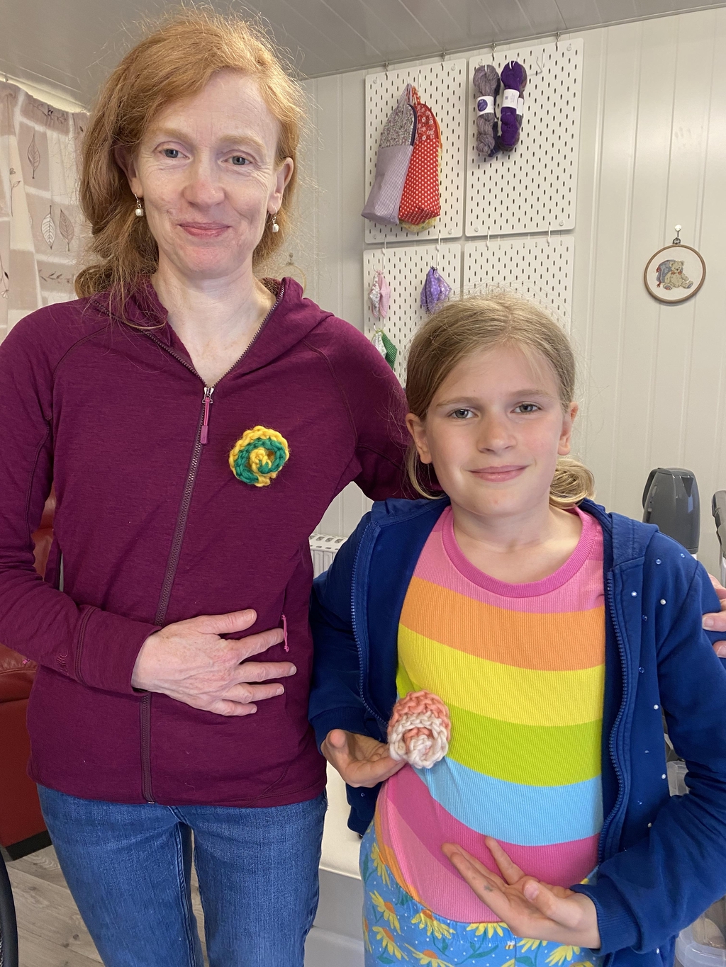 Children displaying their crafts laid out on a table.