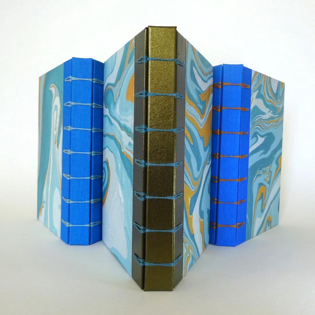 Hardcover notebooks with stitched spine made from repurposed leather