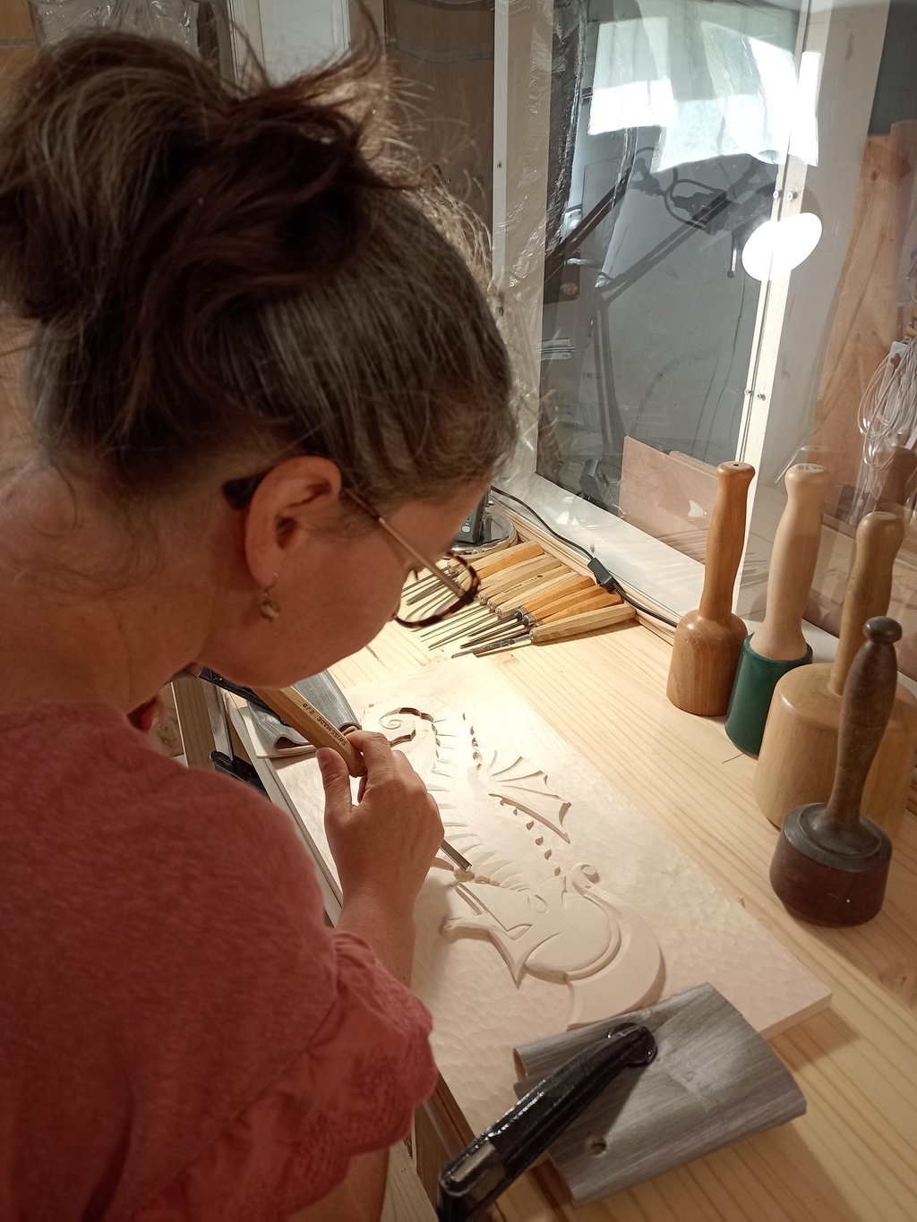 Mélanie Haudry sculptant des pièces en bois pour les mettre en vente