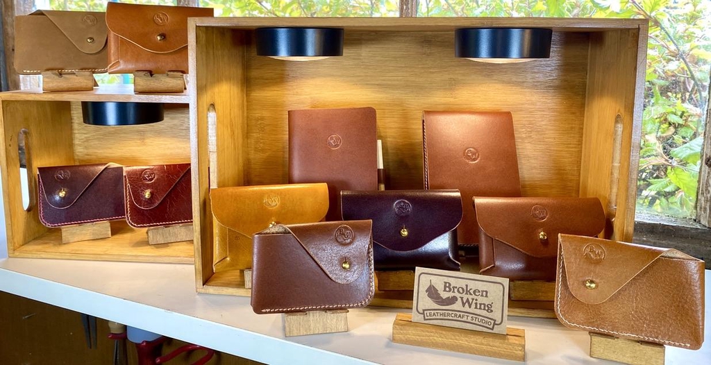 Photo showing the range of Broken Wing Leathercraft Studio card holders displayed in down lit wooden crates with the Headline "We're Off to Market..." and "Join us at the Pyramid Design Market
in Glasgow on Sat 4th July.
More details soon.."