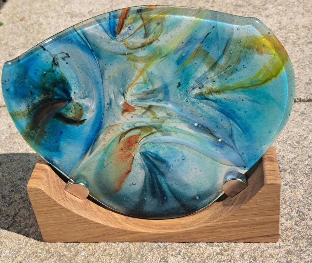 My love of glass fusing began in 2017 under the guidance of Gillian Hulse.

In 2018 I had tuition in Silver-clay with Sandsfoot Jewels and love the alchemy of creating silver jewellery. In 2024 I completed beginners silversmithing course with The Jewellery Academy and applied for my Sponsor mark with Birmingham Assay Office.

I love creating, quality, dynamic, handcrafted fusion jewellery that become personal and treasured pieces.  I also create a large range of home & garden items.

I especially adore designing and creating larger "Statement pieces" for exhibitions and galleries. 

I started running workshops in both silver-clay and glass in 2021 and enjoy helping people find their creative spark and giving people some mindfulness.

I love taking commissions and I'm very happy to discuss any ideas as anything is possible in glass and silver. 
