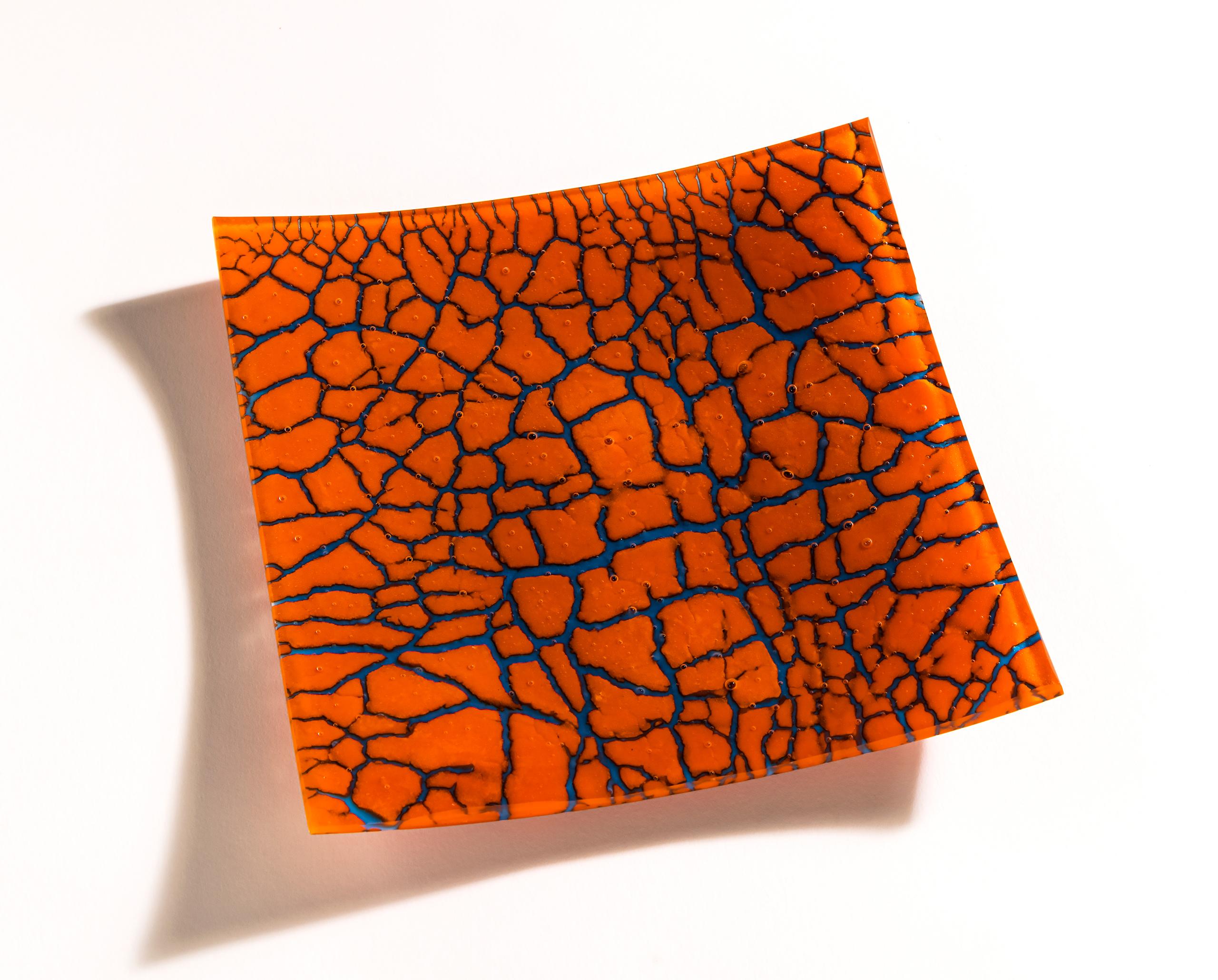 Glass artwork featuring abstract tree-like shapes