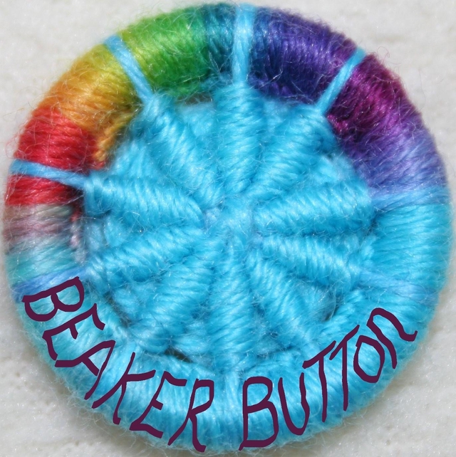 Rainbow and sky blue Dorset button with beaker Button written around the rim