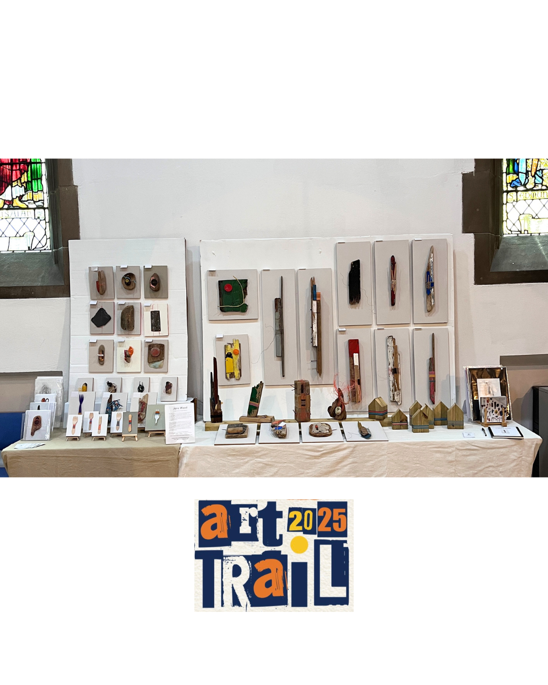 3D Recycled wall art sculpture and assemblage The image show a long table in a church hall displaying a range of found objects and wall sculptures and assemblage of different sizes and colours. They are made from wood and rope threads using hand construction methods such as, binding, knotting, stiching and weaving.