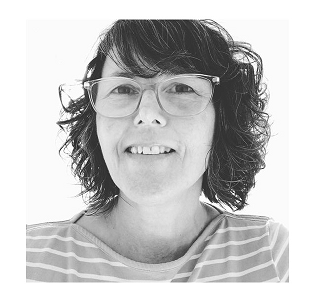 JaneLWood - 3D sculpture and assemblage Transforming found objects by hand in Leeds, studio at Sunny Bank Mills.

Image shows a black and white photography of the artist who is wearing a striped top and glasses.  She has shoulder length, dark curly hair and is smiling. 