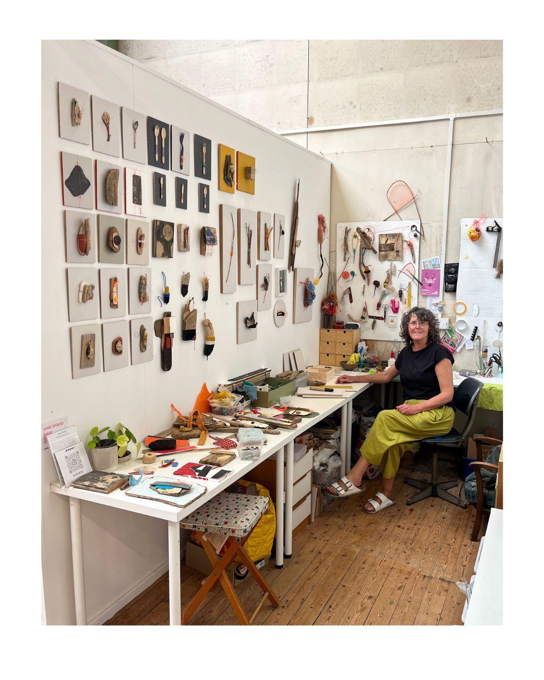 Jane Wood | contemporary sculpture and assemblage | The image shows a white wall with a range of small objects displayed that are made from found objects and materials.