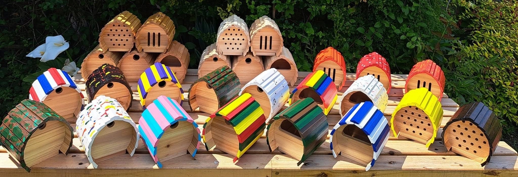 A selection of basic, varnished and painted nesting boxes for birds and shelters for bugs and butterflies.