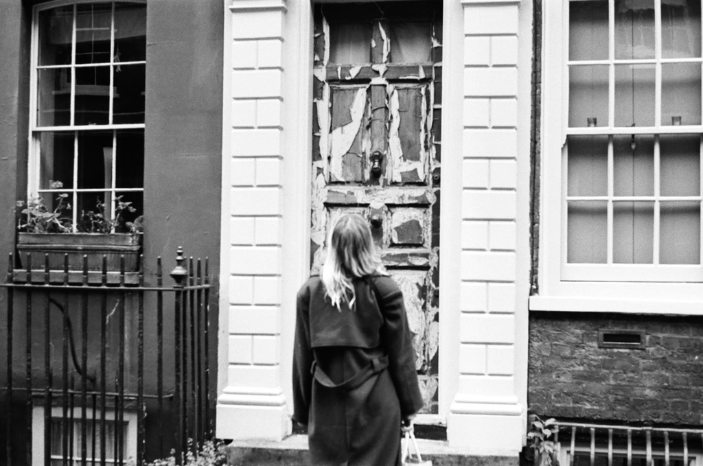 Ella by a rustic door 