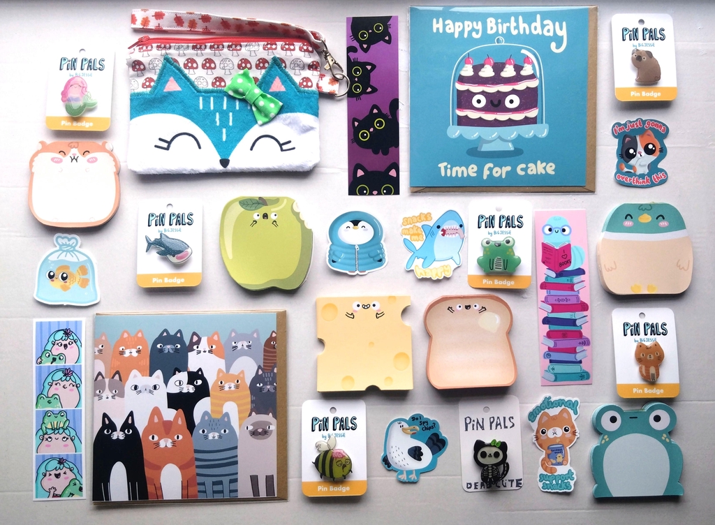 A selection of handmade products, cards, bookmarks, stickers, pin badges, notepads and purse.
