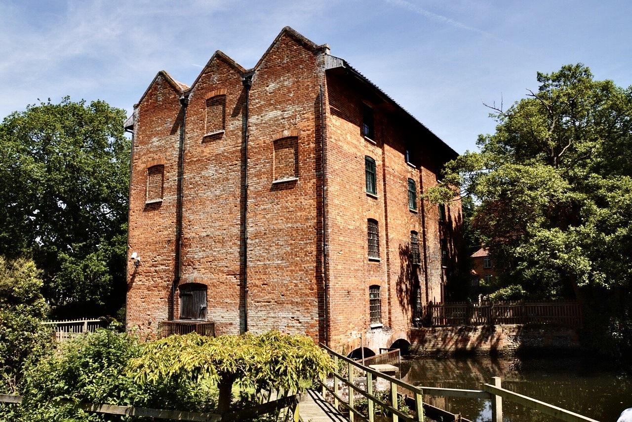 Letheringsett Watermill in Norfolk, a historic red-brick mill beside the river, home to Worn Out Antiques