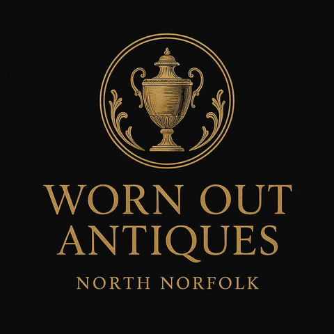 Black and white photograph of a family standing outside a vintage antiques shop on its opening day, accompanied by a Winston Churchill impersonator. The shop sign reads 'Worn Out,' and the image is now used as part of the business logo and story on the website