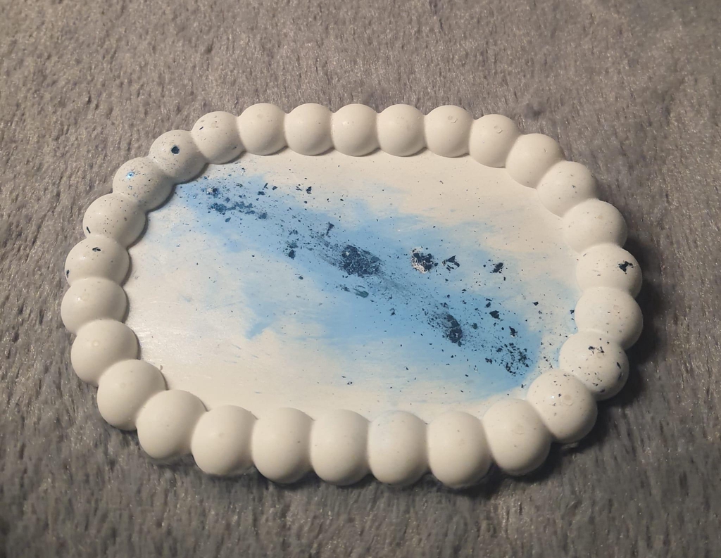 plateau bulle ovale, coulée en jesmonite, avec un effet galaxie bleu et feuille bleuée en diagonale du plateau, le reste est blanc