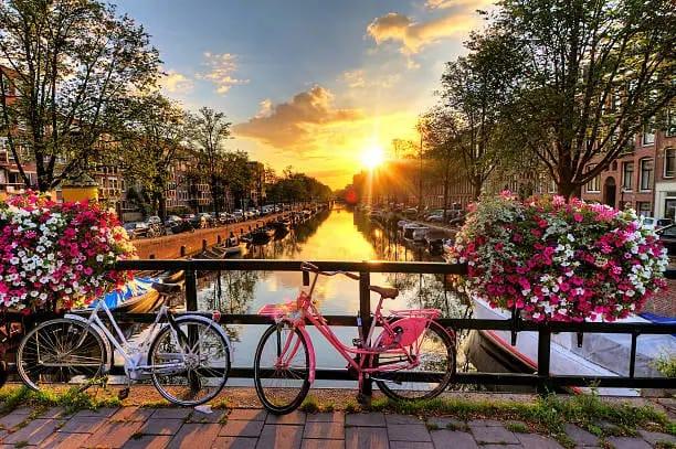Sunset over Amsterdam’s iconic canal, capturing the magical moment of the golden hour on the water