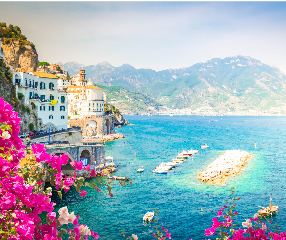 Breathtaking coastal view of the Amalfi Coast in Italy with turquoise Mediterranean waters and soft pink sunset tones