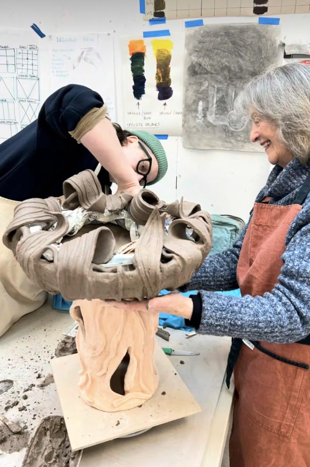 Pottery tutor and student working in clay