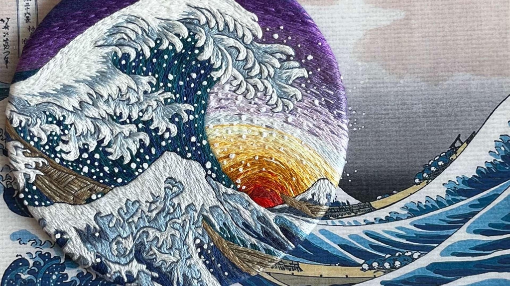 Uma releitura da obra A grande onda de Kanagawa feita com a técnica de bordado impressionista.
Sobre a imagem, o texto: Com tecido, linhas e tintas, crio obras que acalentam, inspiram e convidam a olhar para si e contemplar o momento presente.
Recifense morando em Quebec, enviando obras de arte para todo o mundo.