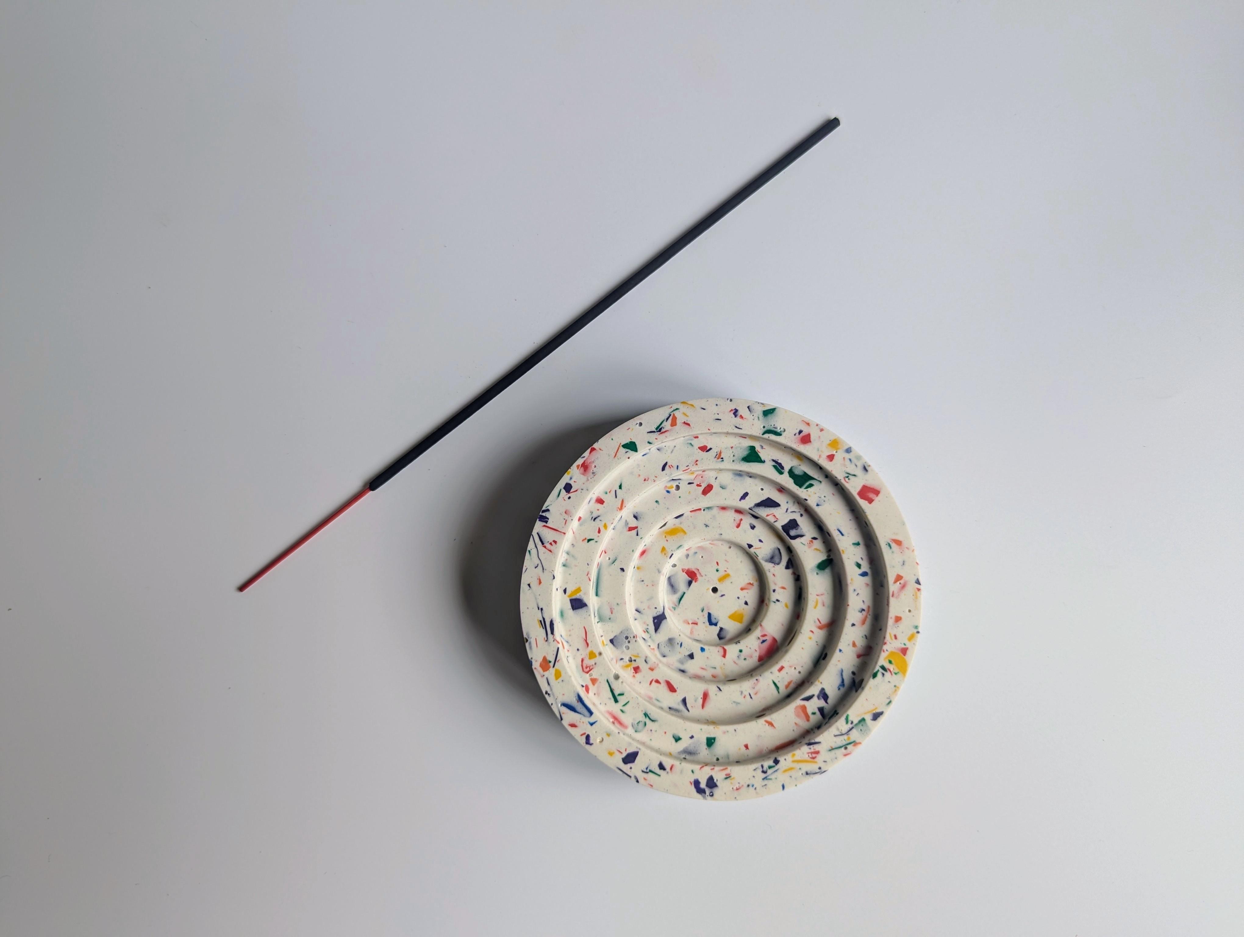 Incense stick and holder in a terrazzo pattern