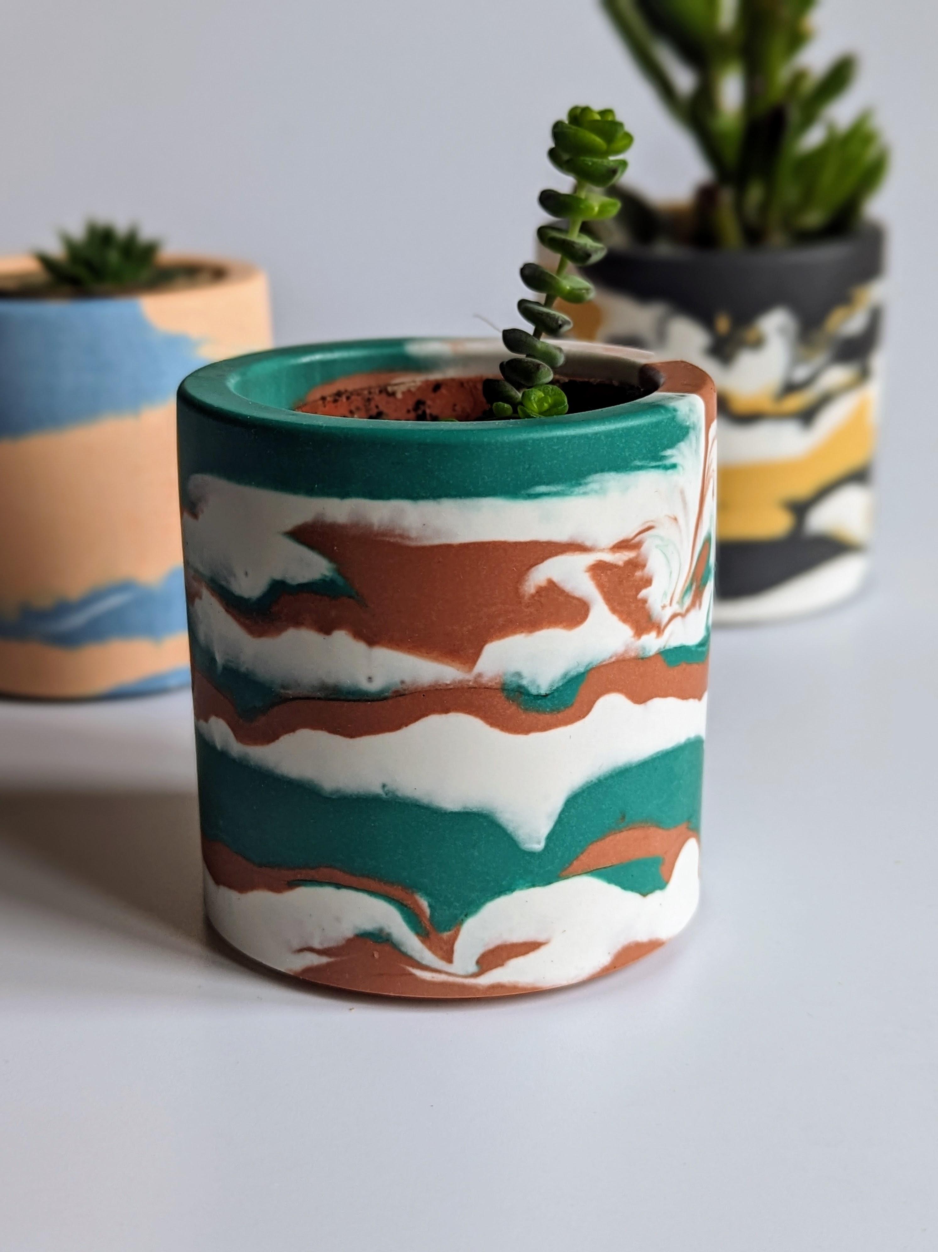 Green and brown small plant pot in an abstract pattern