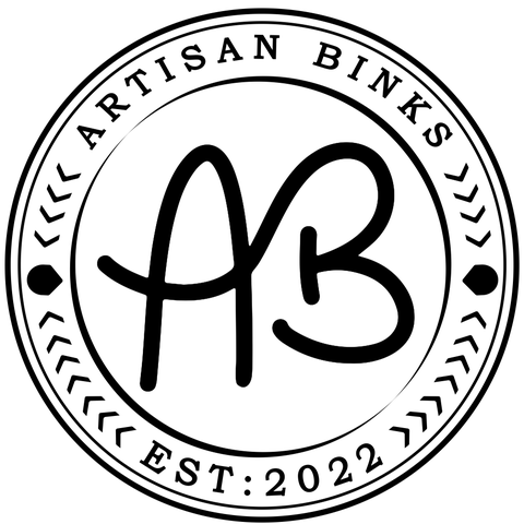 The Artisan Binks Logo, A sweeping connected A&B in a stamped circle with header and footer text stating ArtisanBinks, EST : 2022