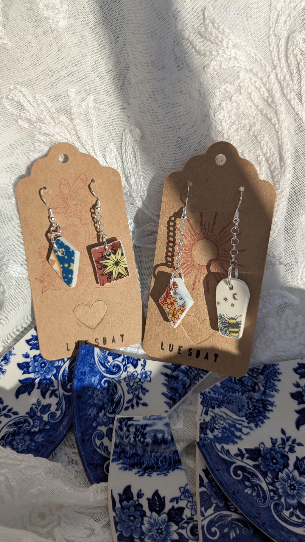 Two sets of handmade earrings with each containing a fragment of a vintage plate. 